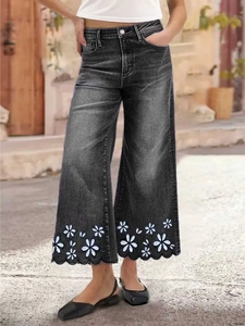 Black washed wide-leg cropped jeans with white flower embroidery and scalloped hem edges