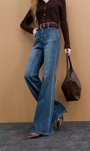 Detail of dark blue high waisted flared jeans with vertical center seam and retro wash