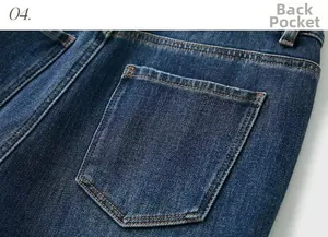 Detailed macro view of the back pocket on deep blue denim jeans with orange stitching