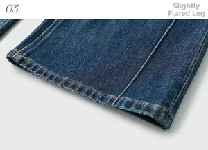 Detail of distressed hem and stitching on dark blue flare leg stretch denim jeans