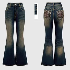 Detail of vintage blue flare jeans with Lost Souls embroidery and red wing pattern
