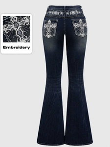 Detailed embroidery of silver waves and stars with sequins on flared denim jeans