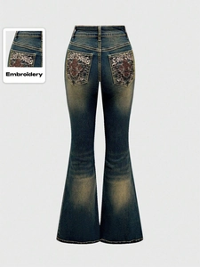 Retro high-waisted flared jeans in dark blue with embroidery and vintage wash finish