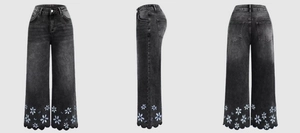 Detail of grey wide-leg jeans with daisy embroidery and scalloped hem design