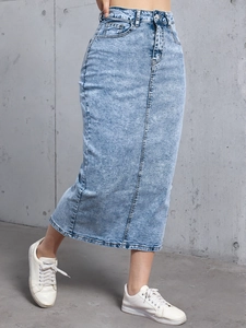 Detailed texture of light blue washed denim midi skirt with classic stitching and high waist