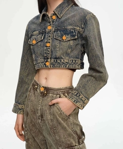 Detail of vintage acid wash cropped denim jacket and matching high waist jeans set