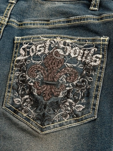 Deep blue flared jeans with intricate Lost Souls embroidery on the back pocket detail