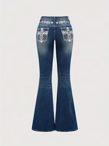 Detail of cross embroidery and sequins on the back pockets of dark blue flared jeans