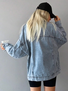 Detailed back view of oversized light blue denim jacket with vintage dropped shoulders