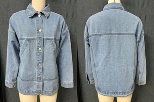 Detail showing the light blue washed denim jacket with silver buttons and loose fit