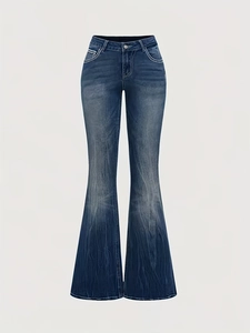 Detail of dark blue flared jeans showing faded wash texture and retro bootcut silhouette
