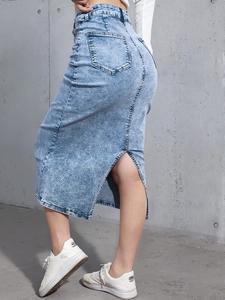 Detail view of light blue denim midi skirt featuring a high waist and back slit design