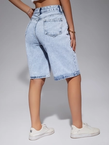 Detail view of high-waisted light blue denim shorts featuring rear pockets and twill texture