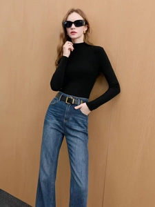 Slim fit black long sleeve sweater with vintage high waist flare jeans and belt