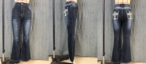 Detailed close-up showing cross embroidery and rhinestone accents on dark blue flare jeans