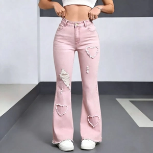 Detail of pink flare jeans with unique heart-shaped distressed cutouts and frayed hems