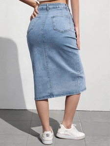 Detail view of high waist light blue denim skirt with back pockets and center seam