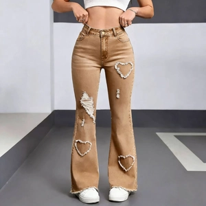 Detail of heart-shaped cutouts and frayed hems on vintage yellow flare jeans