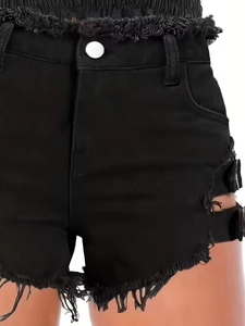 Women's black denim shorts with fringe, side cut-outs, and metal buckle decorations