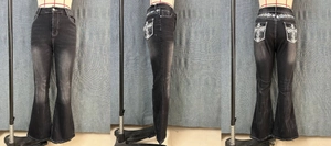 Detail of flared jeans showing cross embroidery with rhinestones on back pocket