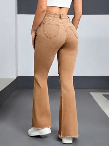 Detail of high-waisted flared jeans with raw hem and symmetric rear pockets