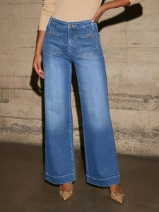Detail of high-waist blue wide-leg jeans featuring square front pockets and gold buttons