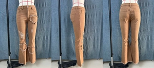Detail view of heart-shaped cutouts and distressed fringe on high-waist brown flare jeans