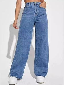 Detail of dark blue high-waisted wide-leg jeans with washed texture and metal button closure