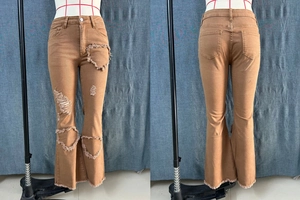 Close-up of high-waist camel flare jeans featuring heart-shaped distressed detailing and frayed hems