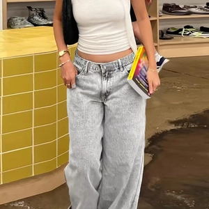 Gros plan sur un jean large taille haute bleu clair avec texture délavée rétro