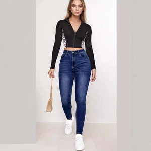 Jeans slim blu scuro abbinati a una felpa nera con inserti zebrati di tendenza
