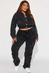 Détail d'une veste courte en jean délavé gris foncé avec poches cargo et boutons en métal