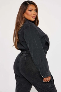 Gros plan sur la veste en jean noir délavé avec poches à rabat et texture vintage