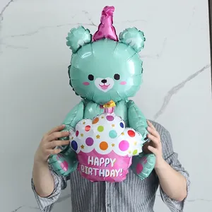 Detail of 3D mint green bear foil balloon holding a Happy Birthday cupcake decoration