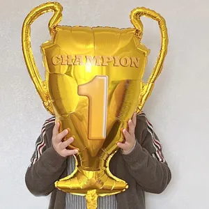 Large golden trophy foil balloon with Champion Number 1 design for victory celebrations
