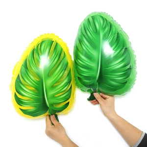 Detailed view of large monstera leaf foil balloons with realistic green textures