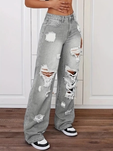 Detail von grauen High-Waist-Jeans mit weitem Bein und modischen Rissen im Streetstyle-Look