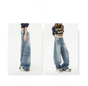 Detail view of baggy fit wide leg jeans in light blue washed denim with raw hems