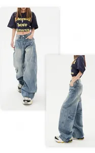 Detail of high-waisted vintage wash blue wide-leg jeans with retro distressed cat whisker texture