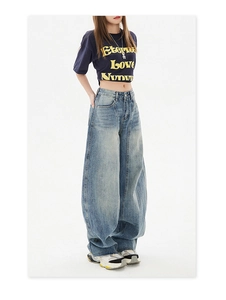Detail of high-waisted light blue washed baggy jeans with oversized vintage street style