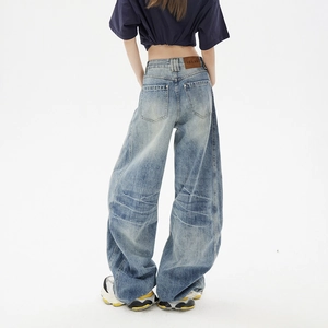 High-waisted light blue wide-leg denim jeans with retro wash and loose fit back view