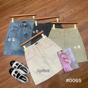 Flat lay of high waist A-line denim skirts in blue, grey, khaki and apricot colors