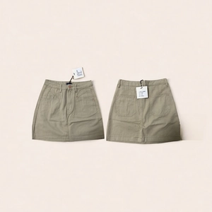 Front and back detail of khaki high waist A-line cotton mini skirt with pockets