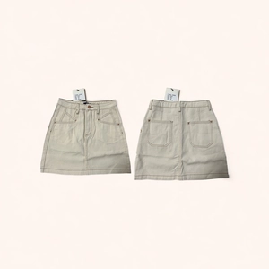 Detailed flat lay of apricot cotton denim skirt showing front and back with pockets