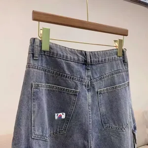 Close-up of washed blue denim shorts featuring high waist and classic back pocket stitching