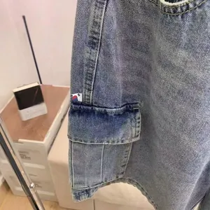 Detail of vintage washed blue denim shorts showing cargo pocket and contrast stitching