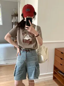 Detail of high-waisted denim cargo shorts with multi-pockets in retro American style