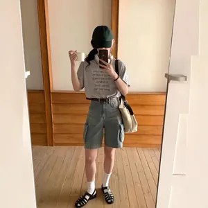 Women's retro cargo denim shorts with grey printed t-shirt for a casual summer look