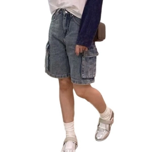 Retro washed denim cargo shorts for women featuring mid-blue wide leg and utility pockets