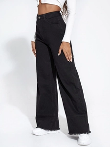 Detail view of high waist black wide leg jeans featuring raw hems and stitched seams